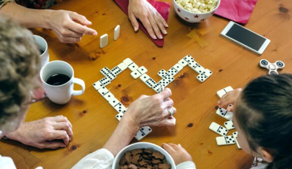 1500×750#high-angle-view-family-playing-dominoes-while-having-food-table